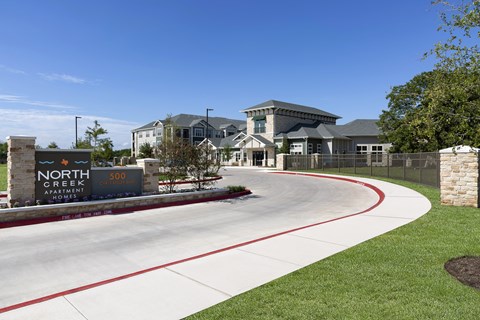 the entrance to the neighborhood apartments